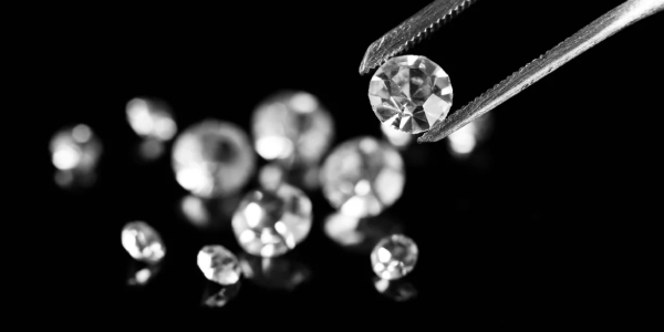 Brilliant Cut Diamond Hold By Tweezers.