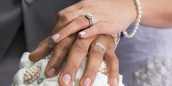 Woman Holding Her Boy Friend's Hand Wearing Elegant Diamond Ring.