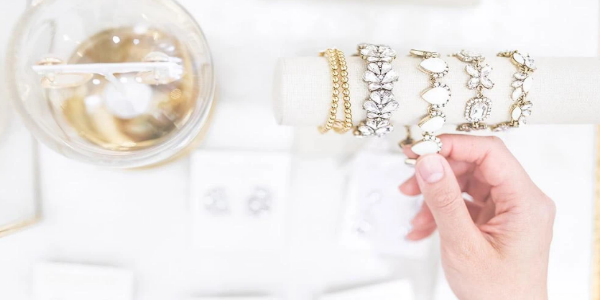 A Human Hand Arranging Her Gold Ornaments For Preventing Gold Tarnishing.