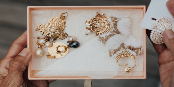 A Human Hand Taken Gold Plated Jewels From The Storage Box.